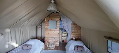 Un ou plusieurs lits dans un hébergement de l'établissement Tente lodge la Flavignienne