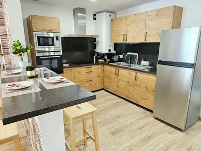 Cuisine ou kitchenette dans l'établissement Rez de chaussée appartement à Tournus - Yellow