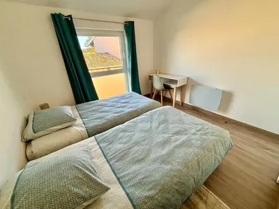Un ou plusieurs lits dans un hébergement de l'établissement Grange rénovée en duplex idéalement située