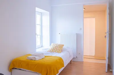 Un ou plusieurs lits dans un hébergement de l'établissement La Pause Péronnaise - Maison de ville en coeur de village