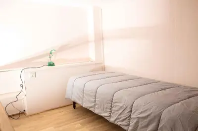 Un ou plusieurs lits dans un hébergement de l'établissement Grand Appartement a Maison sculptée