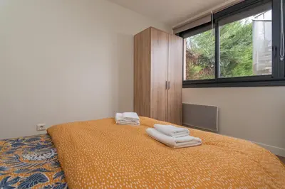 Un ou plusieurs lits dans un hébergement de l'établissement Le Pied à Terre de Montcenis - Appt avec parking privé