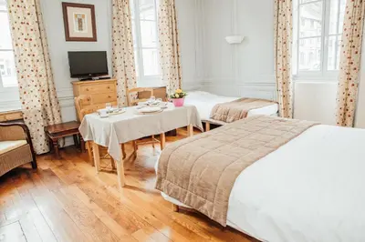 Un ou plusieurs lits dans un hébergement de l'établissement Appart Hotel Charles Sander