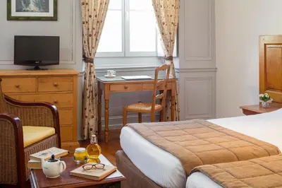 Un ou plusieurs lits dans un hébergement de l'établissement Appart Hotel Charles Sander