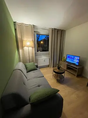 Télévision ou salle de divertissement dans l'établissement Le Wimbledon