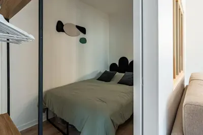 Un ou plusieurs lits dans un hébergement de l'établissement Casa Nena, nid douillet , quartier BSB, République