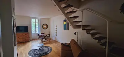 Télévision ou salle de divertissement dans l'établissement Le duplex
