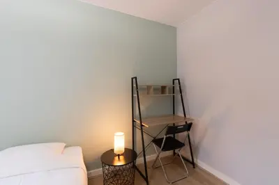 Un ou plusieurs lits dans un hébergement de l'établissement Appart'Hotel Tournusien