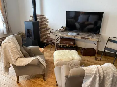 Télévision ou salle de divertissement dans l'établissement Le Moulin de Visargent