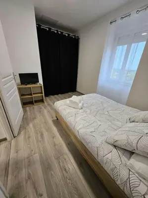 Un ou plusieurs lits dans un hébergement de l'établissement Appartement Saint-Vallier 71