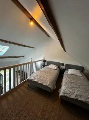 Un ou plusieurs lits dans un hébergement de l'établissement Petite maison de charme à Thury