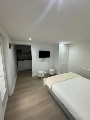 Un ou plusieurs lits dans un hébergement de l'établissement Bel appartement rez-de-chaussée