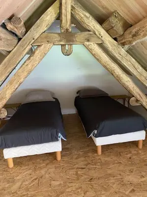 Un ou plusieurs lits dans un hébergement de l'établissement Gîte L'Atelier d'Emile