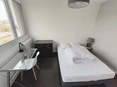 Un ou plusieurs lits dans un hébergement de l'établissement Appartement 3 chambres - Drapeau