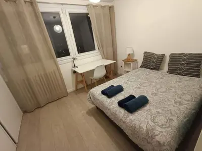 Un ou plusieurs lits dans un hébergement de l'établissement Appartement 3 chambres - Drapeau