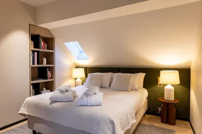 Un ou plusieurs lits dans un hébergement de l'établissement Les Suites by Cave Vauban