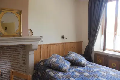 Un ou plusieurs lits dans un hébergement de l'établissement Hotel Camping sur Yonne