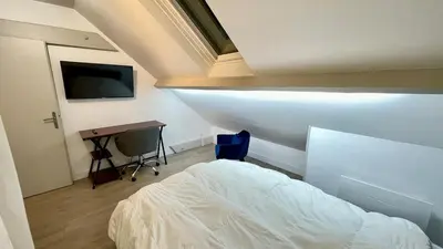 Un ou plusieurs lits dans un hébergement de l'établissement Le Chablis - Proche Centre & CHU, avec MiniBar