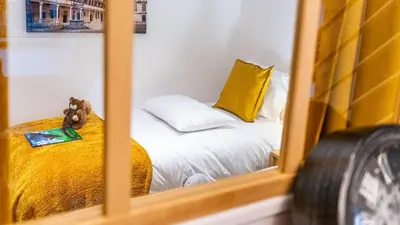 Un ou plusieurs lits dans un hébergement de l'établissement La Maison Mercier