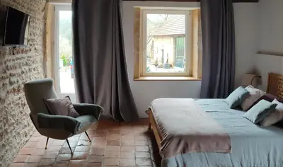 Un ou plusieurs lits dans un hébergement de l'établissement La Coquille, chambre douillette auprès d'un élevage d'escargots