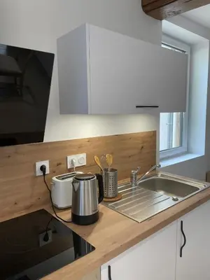 Cuisine ou kitchenette dans l'établissement Appartement calme et chaleureux