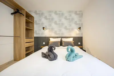 Un ou plusieurs lits dans un hébergement de l'établissement Le Royal Dole - Parking Gratuit - Appartement Moderne & Cosy
