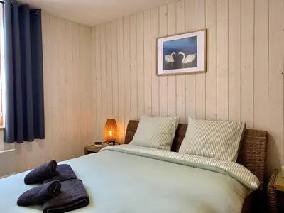 Un ou plusieurs lits dans un hébergement de l'établissement Petite Maison Cosy