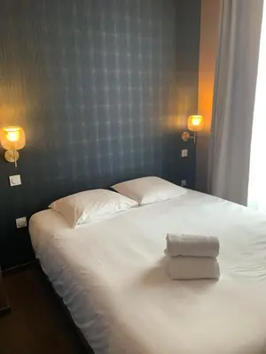 Un ou plusieurs lits dans un hébergement de l'établissement Legend Majestic - Parking Privé GRATUIT- Climatisation - Gare - Centre Ville - FIBRE