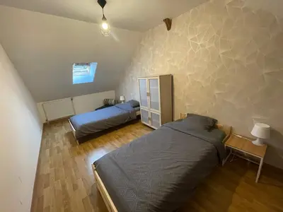 Un ou plusieurs lits dans un hébergement de l'établissement Petite maison avec cour