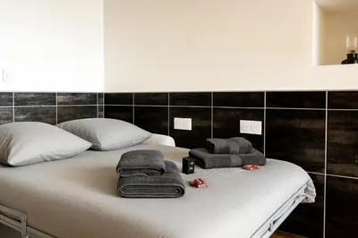 Un ou plusieurs lits dans un hébergement de l'établissement Le Prestige Mâconnais Calme Central Luxe