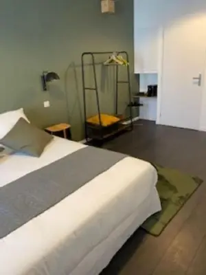 Un ou plusieurs lits dans un hébergement de l'établissement L'Atrium Chambres d'Hôtes