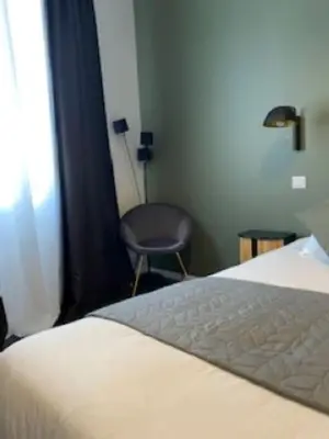 Un ou plusieurs lits dans un hébergement de l'établissement L'Atrium Chambres d'Hôtes
