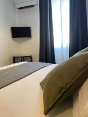 Un ou plusieurs lits dans un hébergement de l'établissement L'Atrium Chambres d'Hôtes