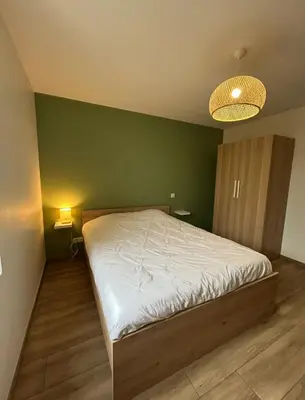 Un ou plusieurs lits dans un hébergement de l'établissement Maison rénovée - Climatisée - Paray-le-Monial - Au bois clair