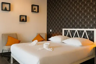 Un ou plusieurs lits dans un hébergement de l'établissement Le Privilège Cosy Central Chic
