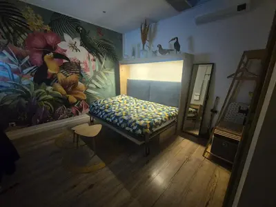 Un ou plusieurs lits dans un hébergement de l'établissement Studio avec Spa Privatif & Terrasse Jungle Dijon Centre
