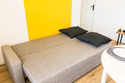 Un ou plusieurs lits dans un hébergement de l'établissement Appart'HomeStudio Mâcon - PARKING