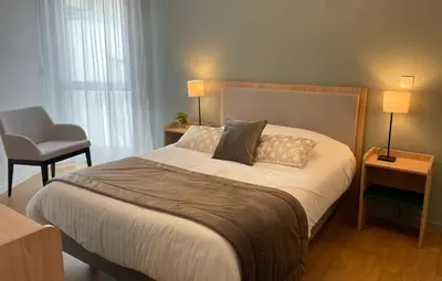 Un ou plusieurs lits dans un hébergement de l'établissement Zenao Appart'hôtels Dijon