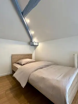 Un ou plusieurs lits dans un hébergement de l'établissement Maison cosy à côté de Beaune