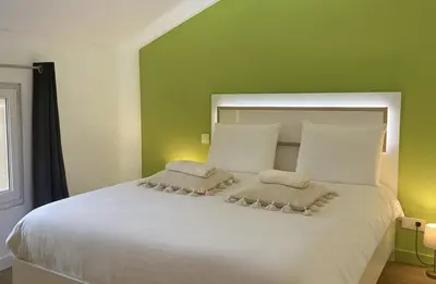 Un ou plusieurs lits dans un hébergement de l'établissement Les Loges du Beaujolais Maison Chic et Confort