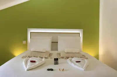 Un ou plusieurs lits dans un hébergement de l'établissement Les Loges du Beaujolais Maison Chic et Confort