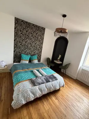 Un ou plusieurs lits dans un hébergement de l'établissement Charmant appartement avec décoration moderne