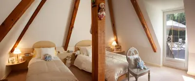 Un ou plusieurs lits dans un hébergement de l'établissement Nuits et Jardin