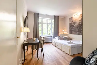 Un ou plusieurs lits dans un hébergement de l'établissement Suite studio Darcy