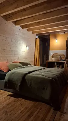 Un ou plusieurs lits dans un hébergement de l'établissement Le Grenier du Moulin