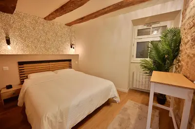Un ou plusieurs lits dans un hébergement de l'établissement Rez de chaussée appartement à Tournus - RIMA