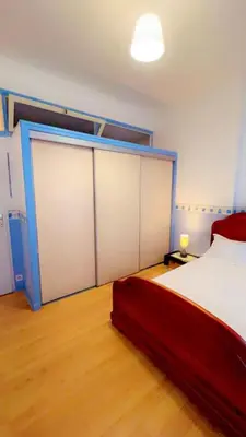 Un ou plusieurs lits dans un hébergement de l'établissement Api Appartement