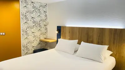 Un ou plusieurs lits dans un hébergement de l'établissement Kyriad Direct Chalon Sur Saone Nord