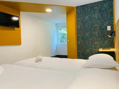 Un ou plusieurs lits dans un hébergement de l'établissement Kyriad Direct Chalon Sur Saone Nord