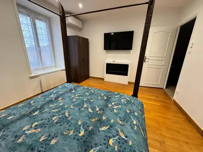 Un ou plusieurs lits dans un hébergement de l'établissement Les Platanes Appartement Le Tropical